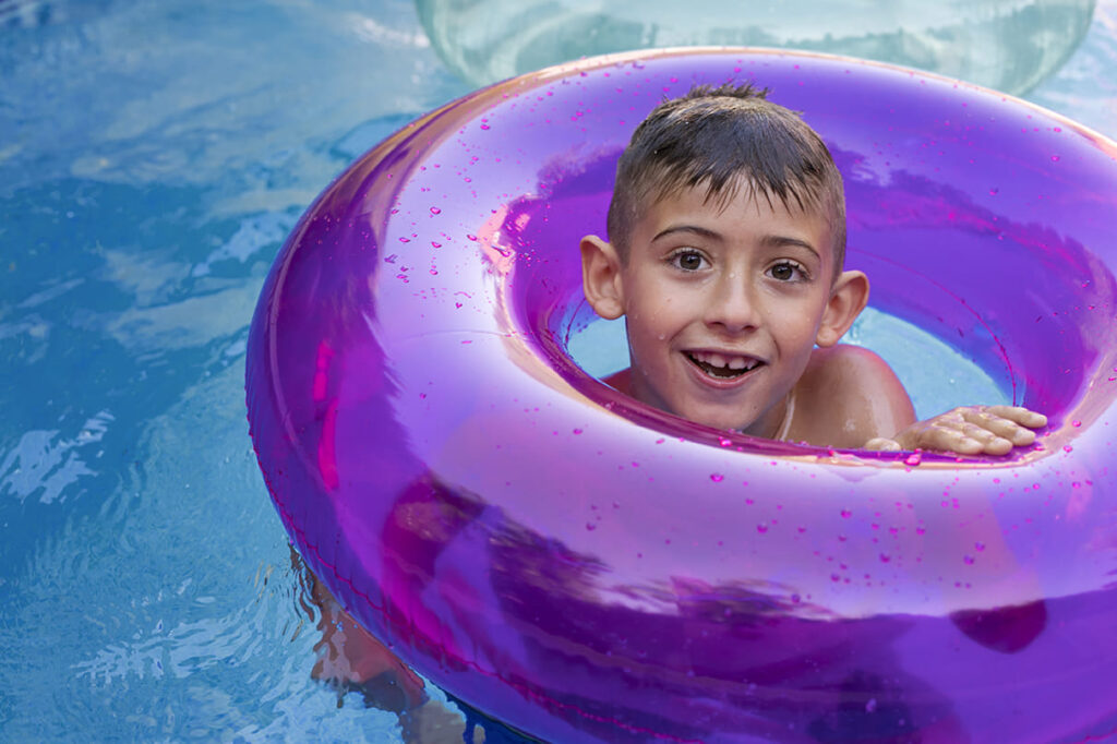 child having fun with floater pool